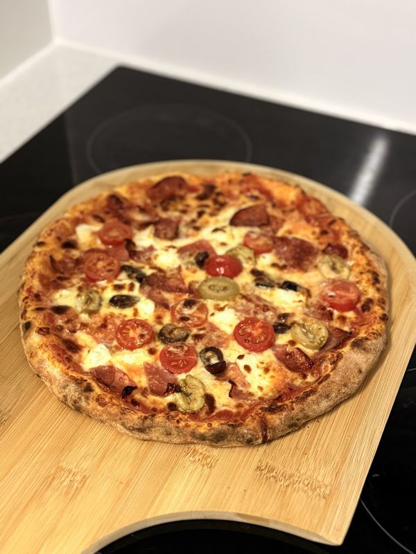 A homemade pizza on a wooden board